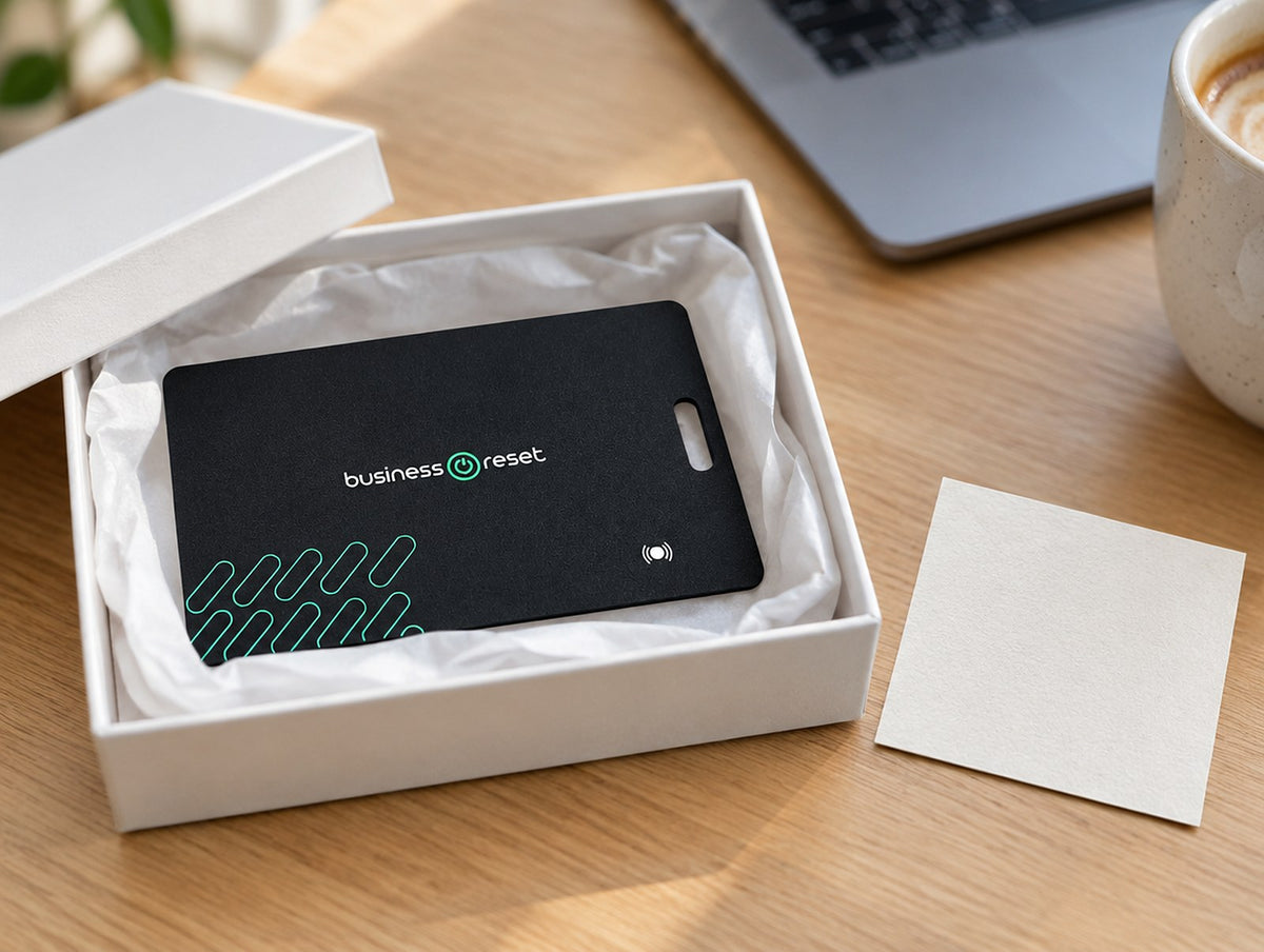 Business Reset branded tracking card in a gift box on an office desk